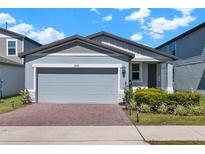 Charming single-story home with a two-car garage, brick driveway, and well-maintained landscaping at 30276 Armenia Rd, Leesburg, FL 34748