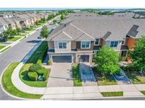 Beautiful townhome showcasing manicured landscaping, paved driveway, and attached garages at 335 Merry Brook Cir, Sanford, FL 32771