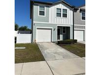 Charming two-story townhouse with an attached garage and well-maintained front yard at 366 Madison Dr, Davenport, FL 33837