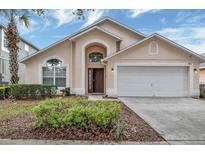 Charming single Gathering home featuring a two-car garage, well-maintained landscaping, and a lovely front entrance at 8471 Secret Key Cv, Kissimmee, FL 34747