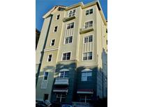 Multi-story condo building with balconies, multiple windows and neutral colored stucco facade at 8761 The Esplanade # 6, Orlando, FL 32836