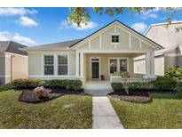 Charming single-Gathering home with well-manicured landscaping and a welcoming front porch at 14673 Tanja King Blvd, Orlando, FL 32828