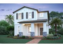 Charming two-story home with a welcoming front porch and stone accents, complemented by a beautifully landscaped yard at 17353 Beachgrass Aly, Winter Garden, FL 34787