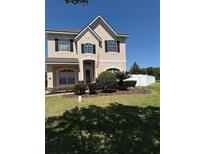 Charming two-story home featuring a well-manicured lawn and inviting curb appeal at 313 Tudor Spring Ct, Orlando, FL 32828