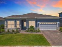 Beautiful single-story home featuring a two-car garage, manicured lawn, and a charming brick walkway at 3182 Sailing Pier Ave, Winter Garden, FL 34787