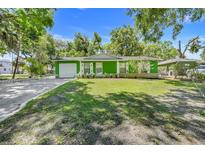 Charming single story home with a well-manicured lawn and an attached garage at 728 E Clifford Ave, Eustis, FL 32726