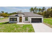 Beautiful single-story home boasts a modern design and well-manicured lawn at 741 Marion Oaks Ln, Ocala, FL 34473