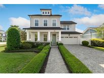 Charming two-story home featuring a manicured lawn, brick walkway, and a welcoming front porch with classic white pillars at 1114 Georgia Blvd, Orlando, FL 32803