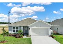 Charming single-story home with a well-manicured lawn, two car garage and beautifully landscaped front yard at 1963 Thompson Preserve Blvd, Bartow, FL 33830