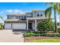 Beautiful two-story home with stone accents, well-manicured landscaping, and a three-car garage at 3417 Michigan St, Lake Mary, FL 32746