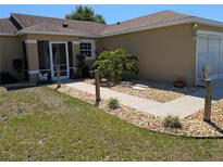 Charming home with a well-maintained front yard, rock garden, walkway, and welcoming entrance at 712 Leonardo Ct, Kissimmee, FL 34758