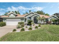 Charming single-story home with a manicured lawn, beautiful landscaping, and inviting curb appeal at 907 Ridge Spring Ct, Apopka, FL 32712