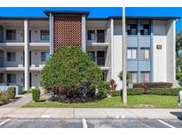 Attractive three-story condo building featuring balconies and a brick accent wall at 11 Escondido Cir # 110, Altamonte Springs, FL 32701