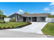 Charming single-story home featuring fresh landscaping, a long concrete driveway, and a freshly painted exterior at 116 Alcala Dr, Kissimmee, FL 34758
