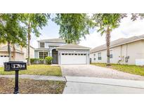 Charming two-story home featuring a brick driveway and well-maintained landscaping at 1204 Blackheath Ct, Davenport, FL 33897