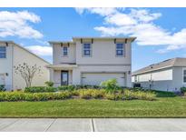 Charming two-story home featuring manicured landscaping and a welcoming front entrance at 978 Commons Way, Port Orange, FL 32129