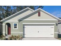 Charming one-story home with a two-car garage, and inviting entryway at 989 Commons Way, Port Orange, FL 32129