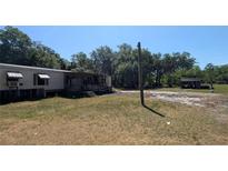 Single-story home featuring a covered porch and a spacious front yard at 1275 Arapaho Trl, Geneva, FL 32732