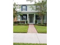 Charming two-story home with a well-maintained lawn and inviting entryway at 14867 Driftwater Dr, Winter Garden, FL 34787