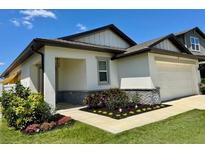 Charming home featuring a welcoming porch and well-manicured landscaping enhancing its curb appeal at 2075 Huntsman Ridge Rd, Clermont, FL 34715