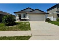 Charming single-story home with a well-manicured lawn and two-car garage at 2075 Huntsman Ridge Rd, Clermont, FL 34715