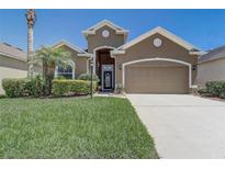 Charming home featuring a two-car garage, well-manicured lawn and appealing curb appeal at 2827 Moonstone Bnd, Kissimmee, FL 34758