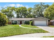Charming single-story home with a well-manicured lawn and a two-car garage at 314 E Bonnie Trl, Longwood, FL 32750
