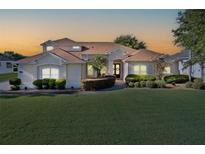Beautiful single-story home featuring a manicured lawn, well-maintained landscaping, and a charming front entrance at 7351 Spring Mountain Ln, Yalaha, FL 34797