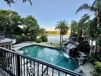 Beautiful pool and spa with waterfall feature overlooks lake at 1105 Lake Nettie Dr, Eustis, FL 32726