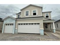 Two-story home featuring a three car garage and stone driveway at 1157 Basalt Ln, Sanford, FL 32771