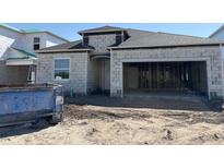 Unfinished exterior elevation of a home featuring cinderblock construction and an attached two-car garage at 1161 Basalt Ln, Sanford, FL 32771