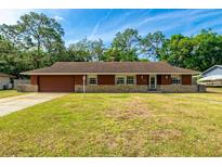 Charming single-story home with a well-maintained lawn and stone accents, providing an inviting curb appeal at 1221 Adams St, Longwood, FL 32750