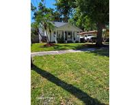 Charming one-story home featuring a manicured lawn, well-kept landscaping, and welcoming front porch at 2114 Gerda Ter, Orlando, FL 32804