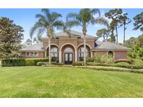 Charming home featuring mature landscaping, well manicured lawn and striking entryway at 2825 Lakeshore Dr, Mount Dora, FL 32757