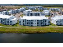 Resort community with multiple buildings, lake view, green spaces and ample parking at 3151 Paradox Cir # 108, Kissimmee, FL 34746