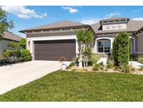 Charming home featuring a landscaped front yard, a neutral color palette, and a two-car garage at 3295 Bailey Ann Dr, Ormond Beach, FL 32174