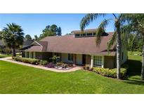 Charming single-story home with well-manicured lawn, mature trees, and beautiful landscaping at 4464 Willow Wind Ct, Orlando, FL 32835