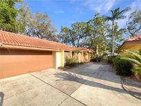 Property with a terracotta roof, a paved driveway, and a two-car garage at 5037 Bermuda Cir # 10, Orlando, FL 32808