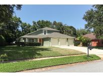 Charming home featuring a three-car garage and well-maintained lawn at 1101 N Division St, Oviedo, FL 32765