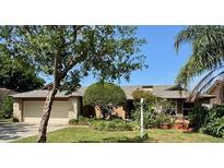 Charming single-story home featuring a two-car garage and well-manicured lawn with beautiful trees and shrubs at 1139 Fairway Dr, Winter Park, FL 32792