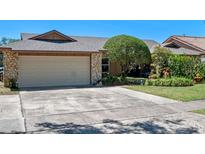 Charming home featuring a stone accent garage, well maintained lawn, and mature trees at 1139 Fairway Dr, Winter Park, FL 32792