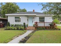 Charming single-story home with a light blue door, small porch, and well-manicured front yard at 24 W King St, Orlando, FL 32804