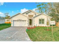 Charming single-story home with a well-manicured front yard and a brick driveway at 341 Bahia Cir, Longwood, FL 32750