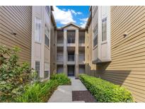 Inviting exterior with well-maintained landscaping and multi-level balconies for each unit at 420 Summit Ridge Pl # 112, Longwood, FL 32779