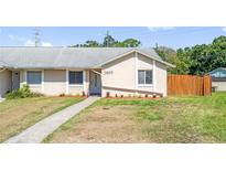 Charming single-story home with a well-maintained lawn and a cozy front entrance walkway at 5809 Willow Bud Ct, Orlando, FL 32807