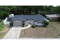 Charming single-story home featuring a well-maintained yard and welcoming facade at 8606 Lsu Ln, Orlando, FL 32817