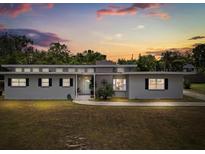 Charming single-story home with a well-manicured lawn at sunset at 932 Campbell Ave, Lake Wales, FL 33853
