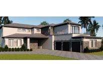 Modern two-story home with dark trim, three-car garage, and beautifully landscaped front yard at 16825 Bolsena Dr, Montverde, FL 34756