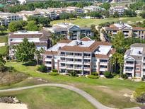 Stunning multi-story condo building boasts golf course views and private balconies perfect for enjoying the outdoors at 1112 Sunset View Cir # 302, Reunion, FL 34747