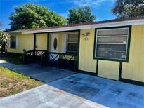 Charming single-story home with a quaint front porch and well-maintained exterior at 235 Crabtree Ave, Orlando, FL 32835